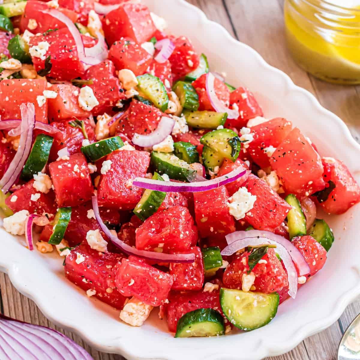 Square image close up of Watermelon Salad on white serving dish.