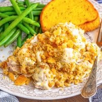 A plate with a serving of Poppy Seed Chicken and side dishes.