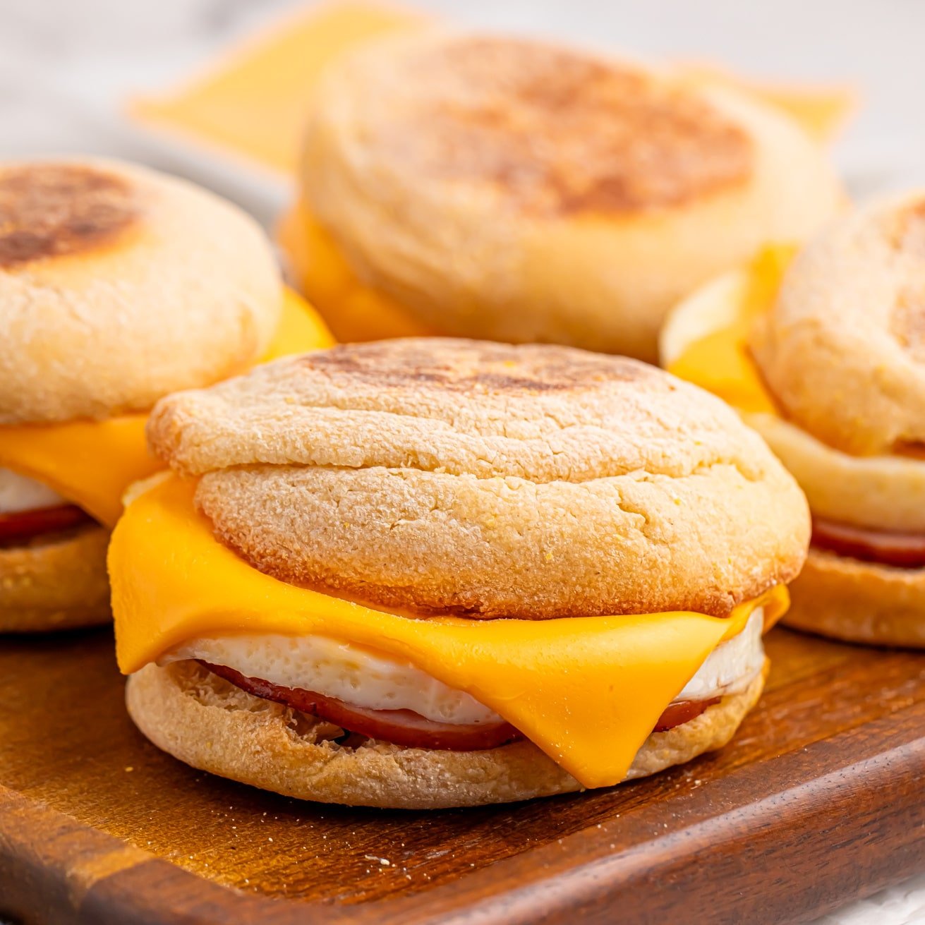 A few Egg McMuffins on a board.