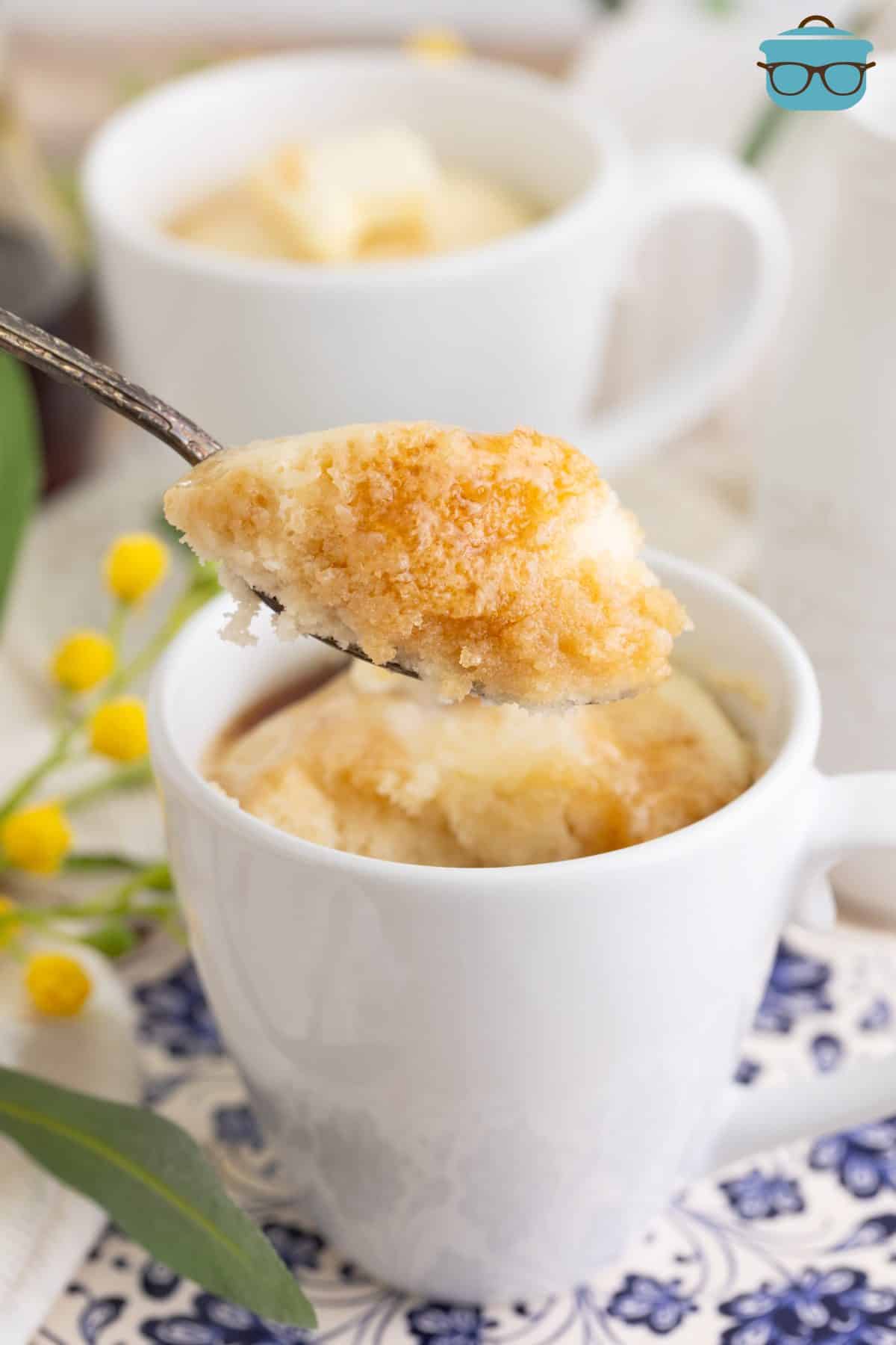 A fork taking a bite of a Pancake in a Mug.