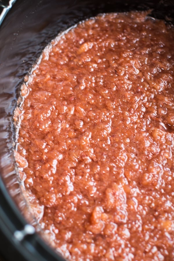 raspberry apple sauce done cooking in a slow cooker.