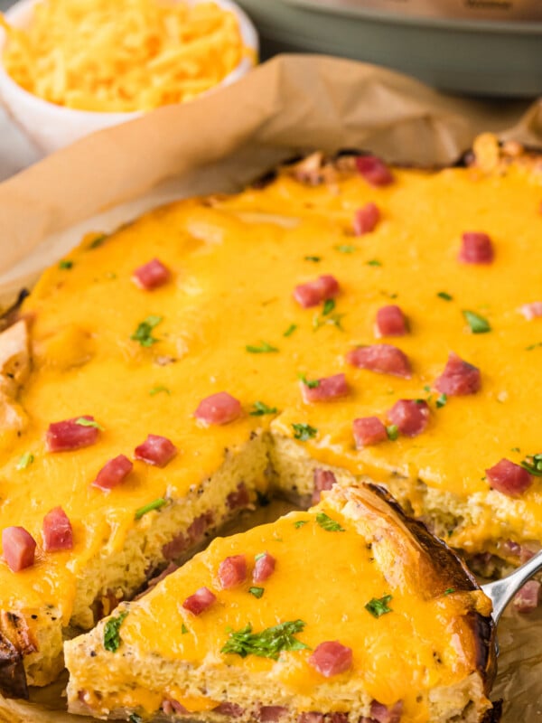 slow cooker quiche with a slice being taken out.