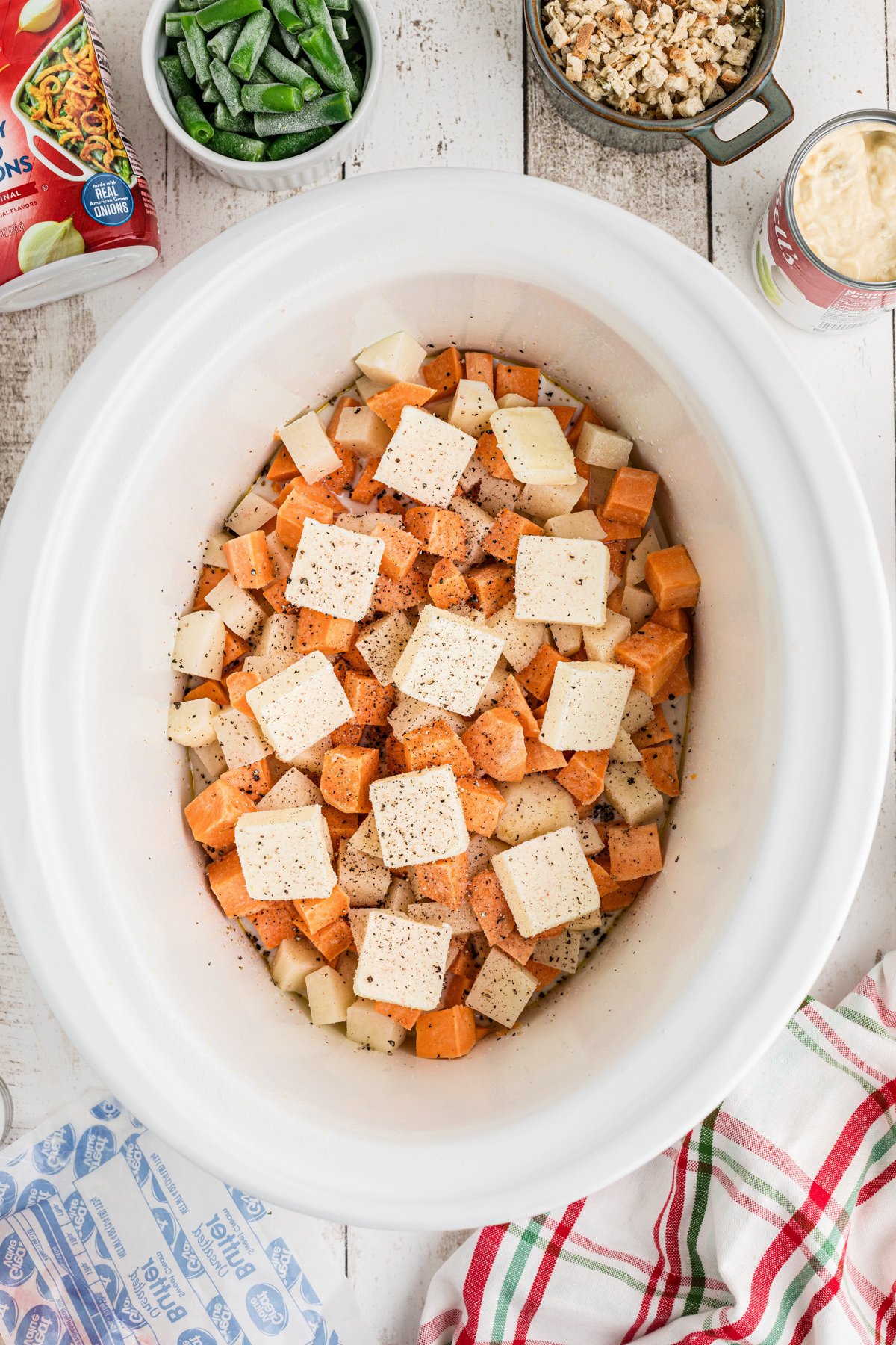 Potatoes and butter in a crockpot.