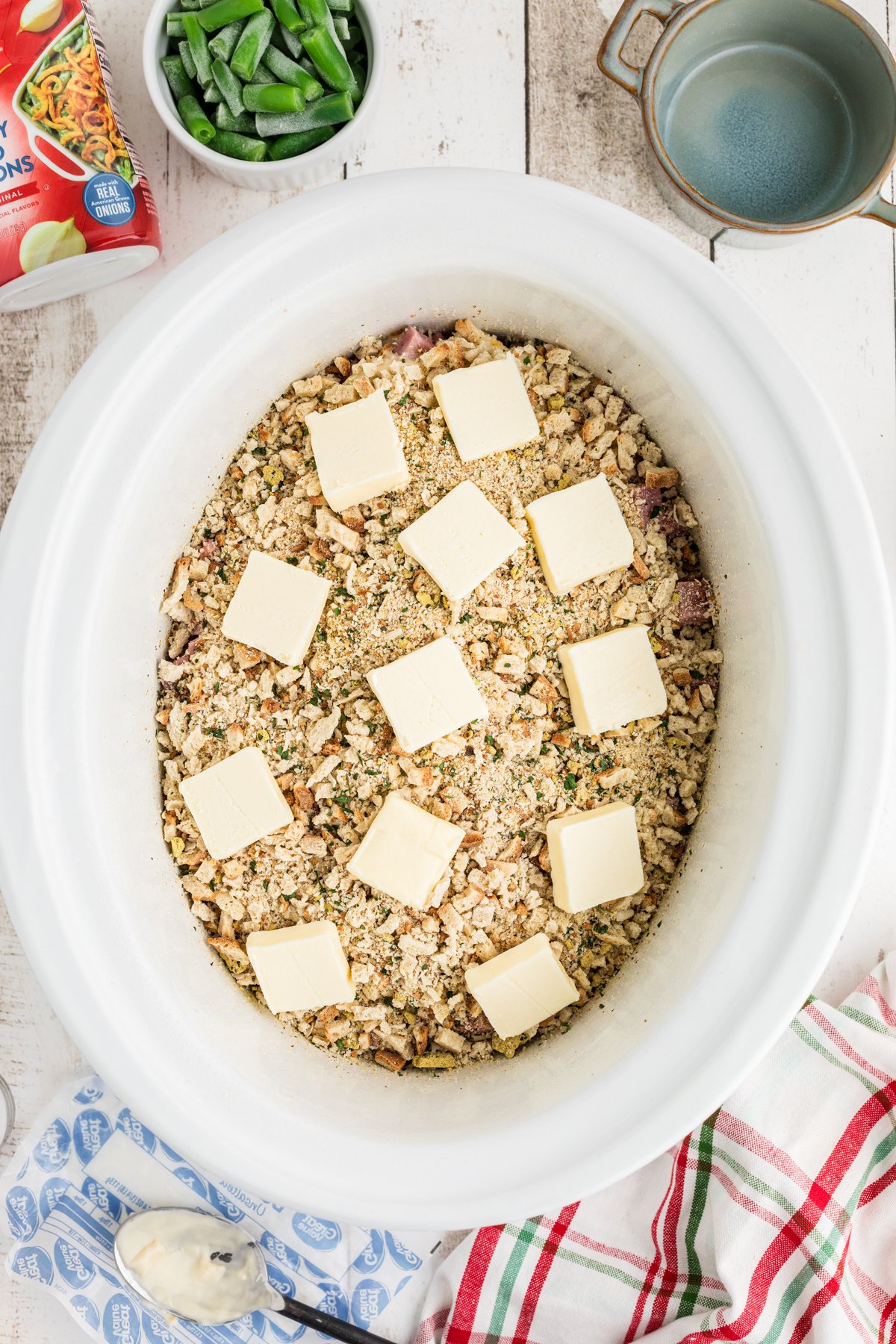 Stove Top stuffing and butter added to a crockpot.