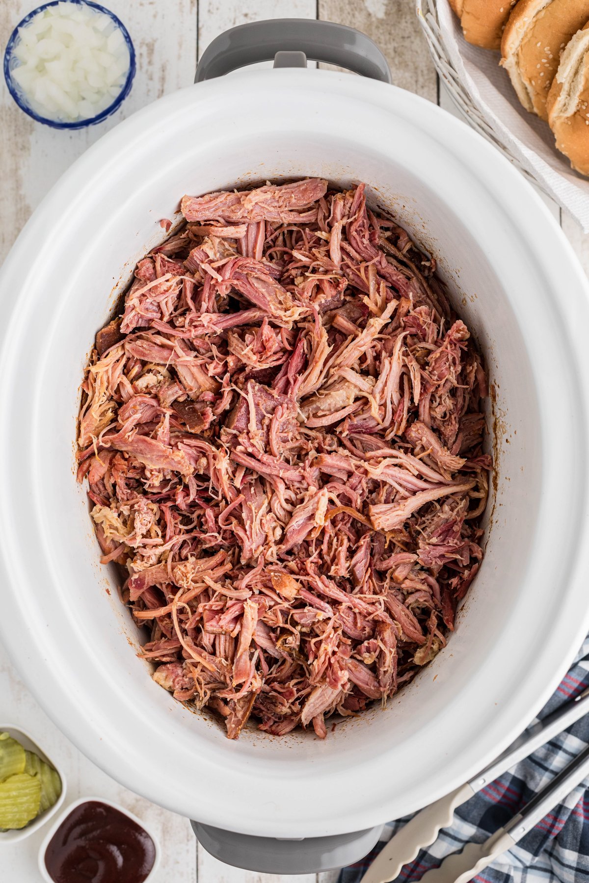 slow cooker pulled ham in a crockpot after cooking.