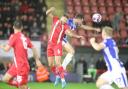 Rise: Leyton Orient's Brandon Cooper challenges Tom Hopper of Colchester United during the Bristol Street Motors Trophy game between the two sides.