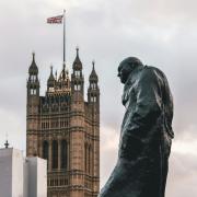 Winston Churchill looks on, outside the Houses of Parliament