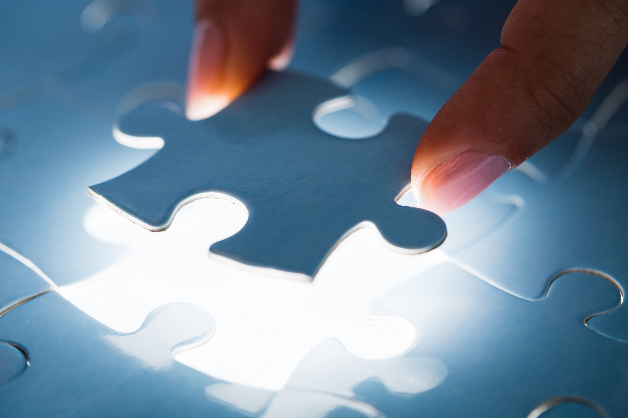 Jigsaw piece being placed on a lightbox