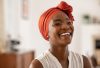 smilingmiddleagedafricanamericanwomanwithorangeheadscarf-beautiful