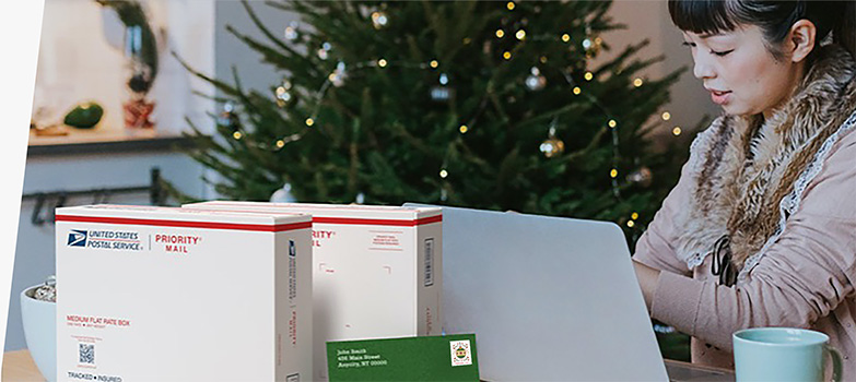 A woman preparing to ship holiday gifts with a Priority Mail Express box and a Priority Mail box.