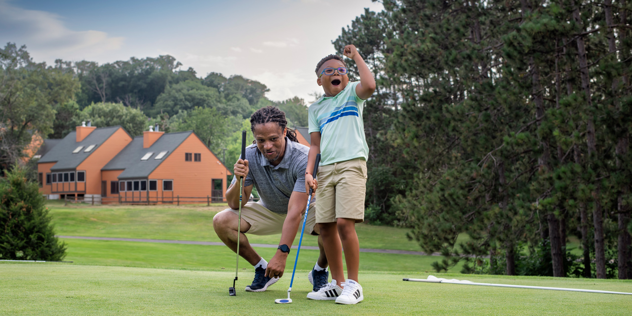 Father and son golfing.