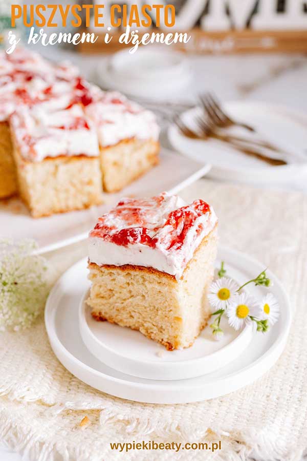 a piece of cake with white frosting and flowers