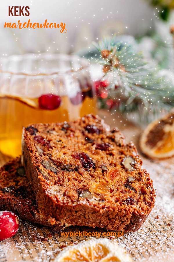 a piece of fruit cake next to a glass of tea